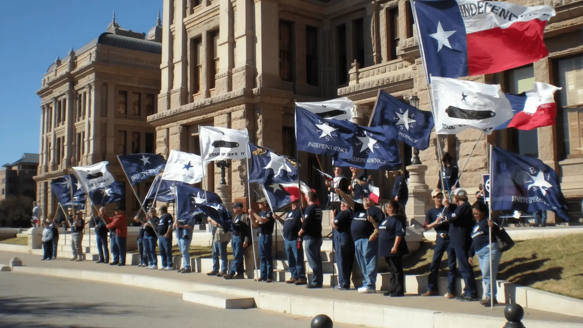 Texians holding Texas independence flags on the steps of the Capitol